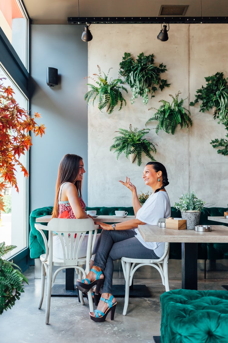 Two Women Talking In Cafe